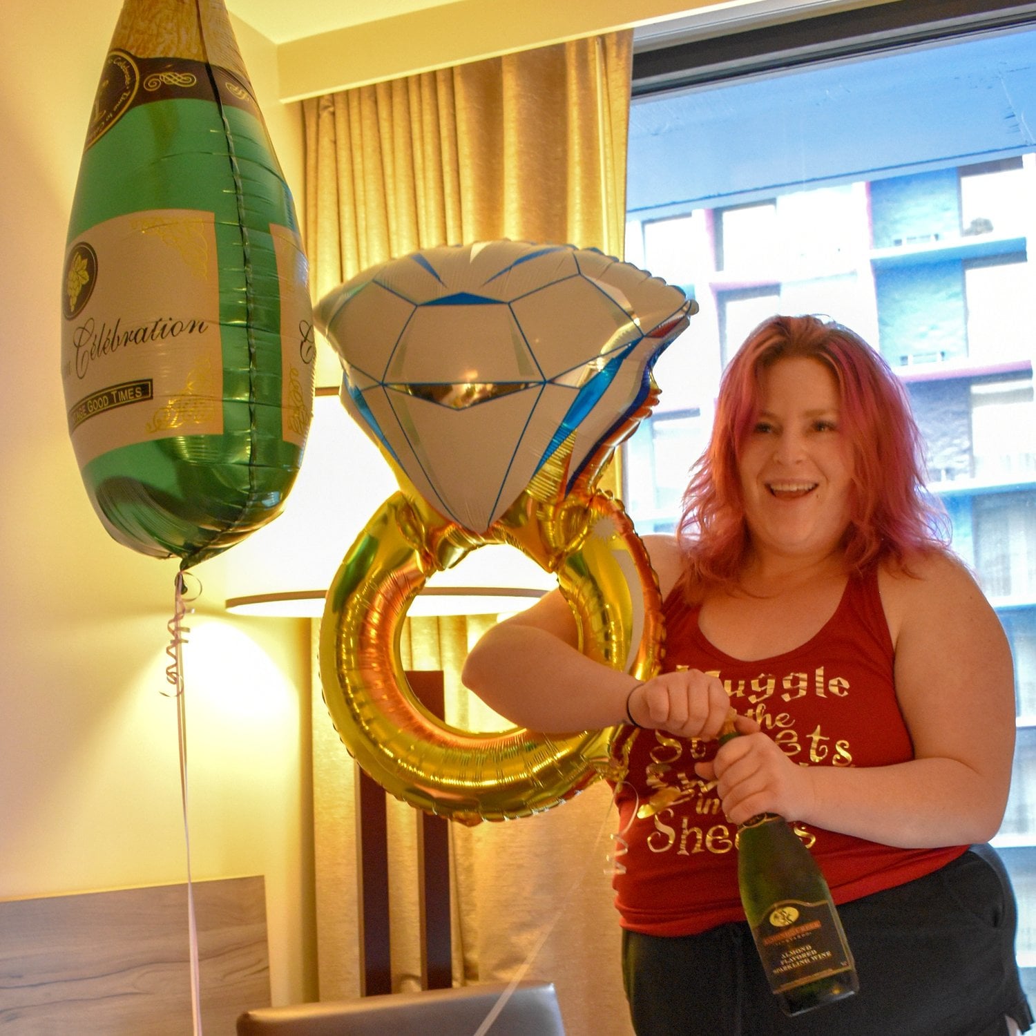 woman opening a bottle of champagne at a bachelorette party in las vegas